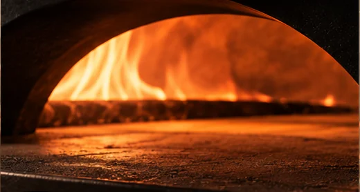 The stone deck glowing inside the oven mouth